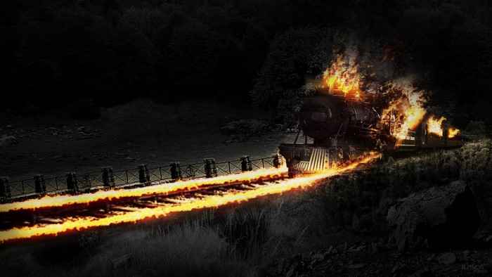 Burning train at night with fiery tracks