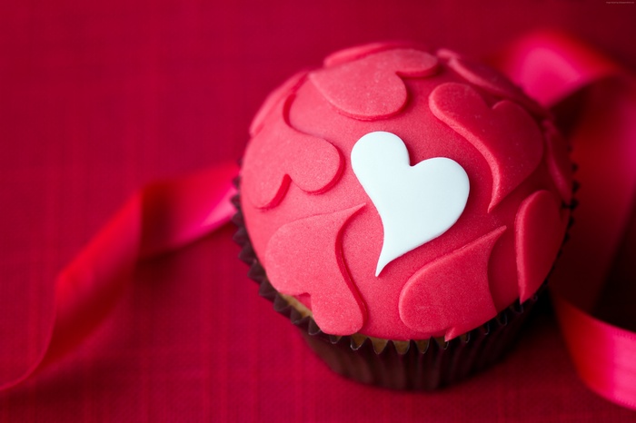 Red cupcake with white heart and pink ribbon