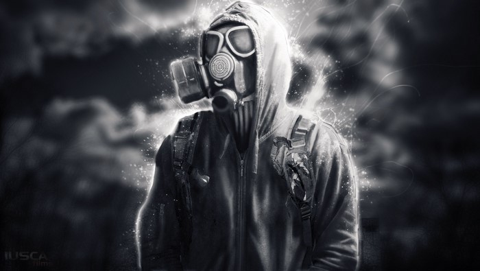 Person in gas mask and hood with glowing effects