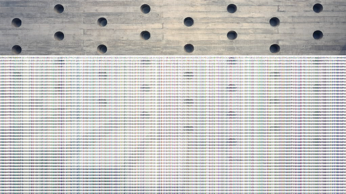 Concrete wall with circular holes and patterned flooring