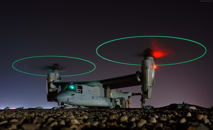 Bell V-22 Osprey tiltrotor military aircraft at night