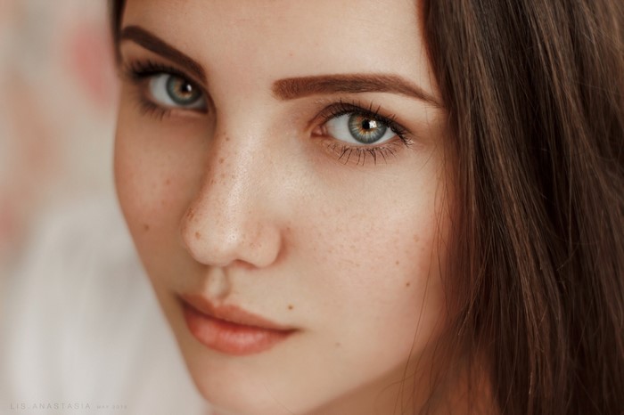 Close-Up Portrait of a Freckled Brunette Woman