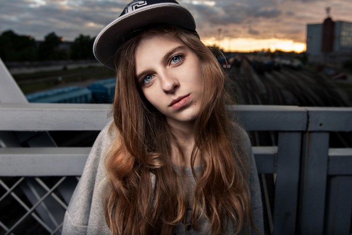 Young woman with blue eyes wearing a baseball cap