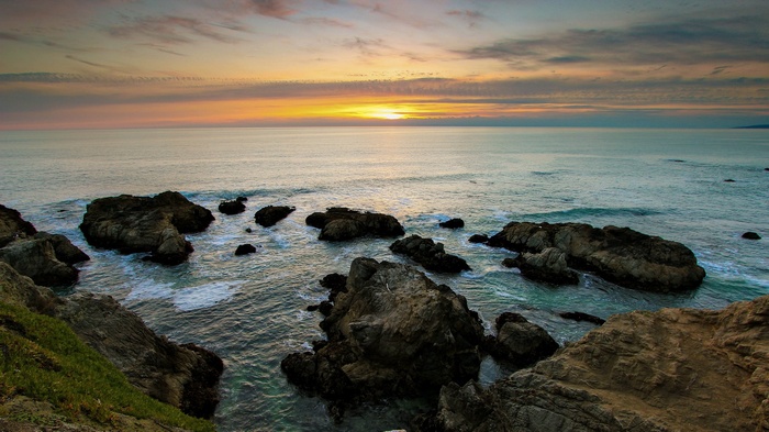 Sunset over the ocean with rocks