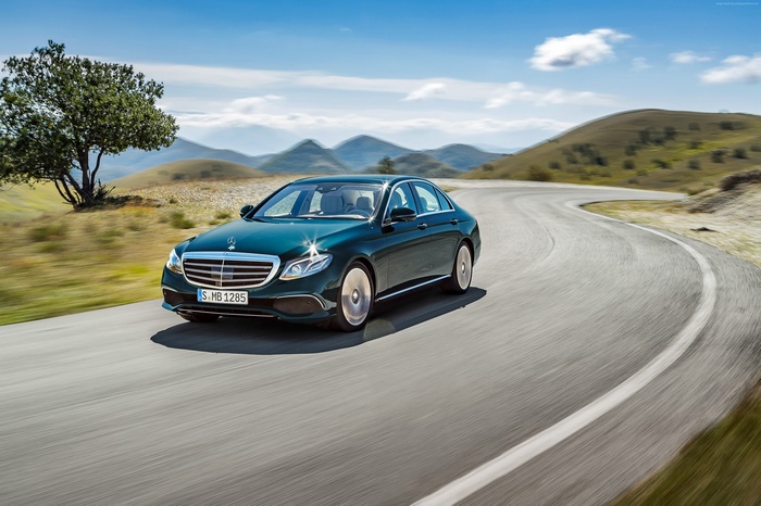 Green Mercedes Benz E 350 Sedan on a Winding Road
