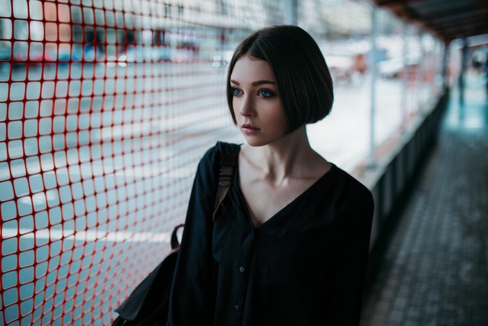 Woman with short brown hair and blue eyes looking away