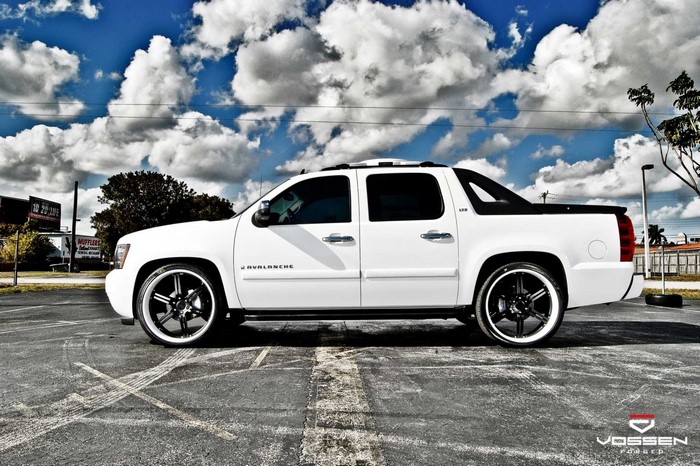 White Chevrolet Avalanche with custom wheels