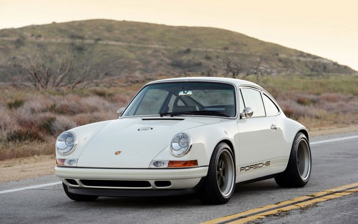 White Porsche 911 sports car on a road