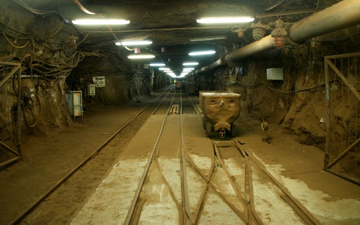 Underground mine tunnel with train tracks and carts in Poland