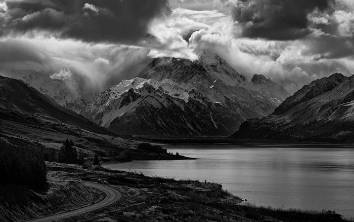 Monochrome mountain landscape with lake and road