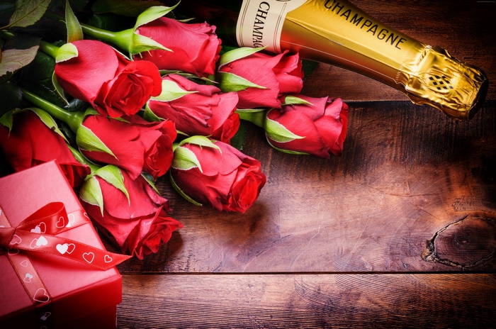 Red roses and champagne bottle with gift box
