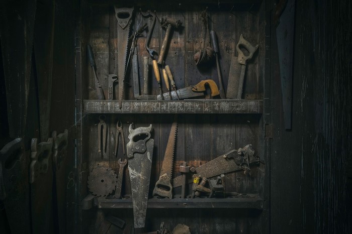 Collection of antique woodworking tools on shelves