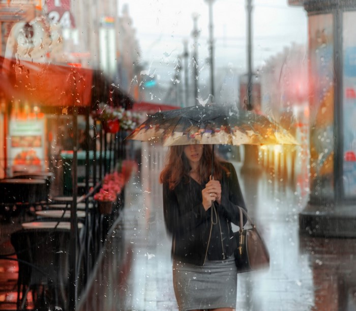 Woman with umbrella walking in the rain in St. Petersburg