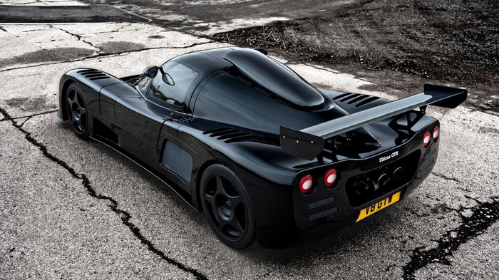 Black Ultima GTR sports car on cracked asphalt