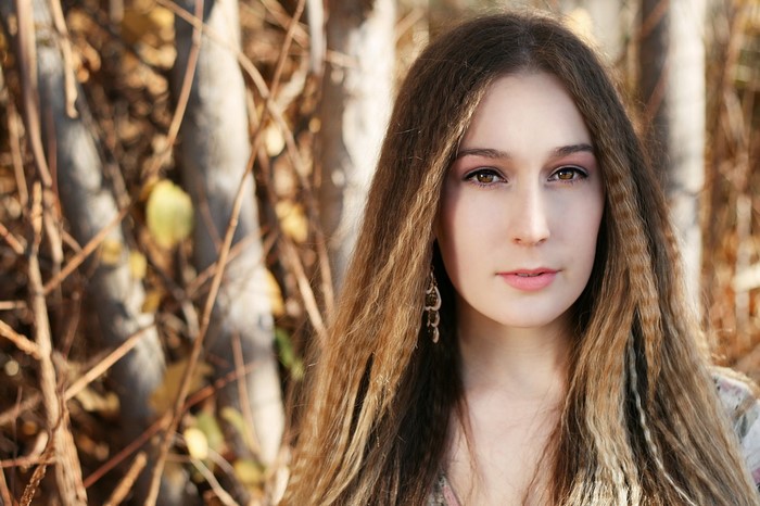 Woman with long brown hair and earrings