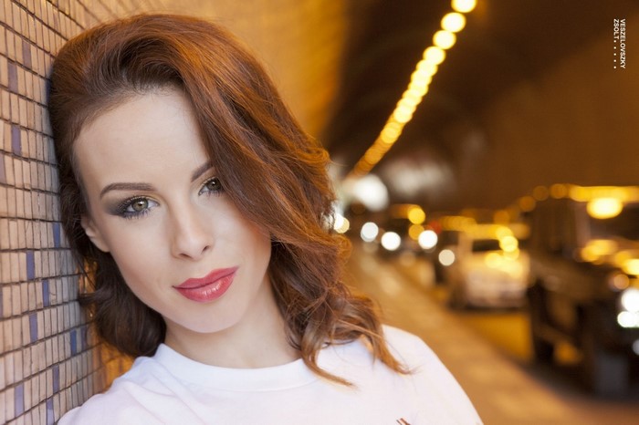 Woman with brown hair in a tunnel