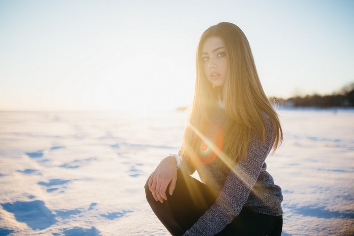 Woman in snow during sunset