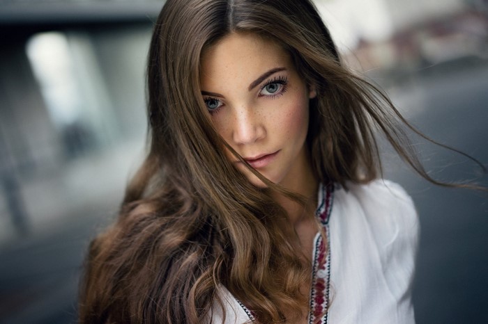 Woman with long brown hair and freckles