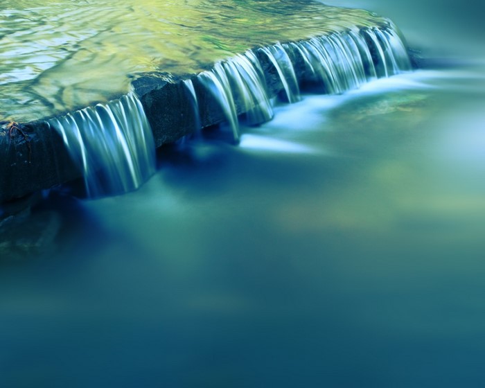 Water flowing over a rock ledge