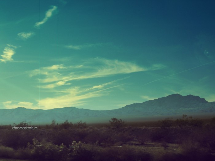 Desert landscape with mountains and clouds