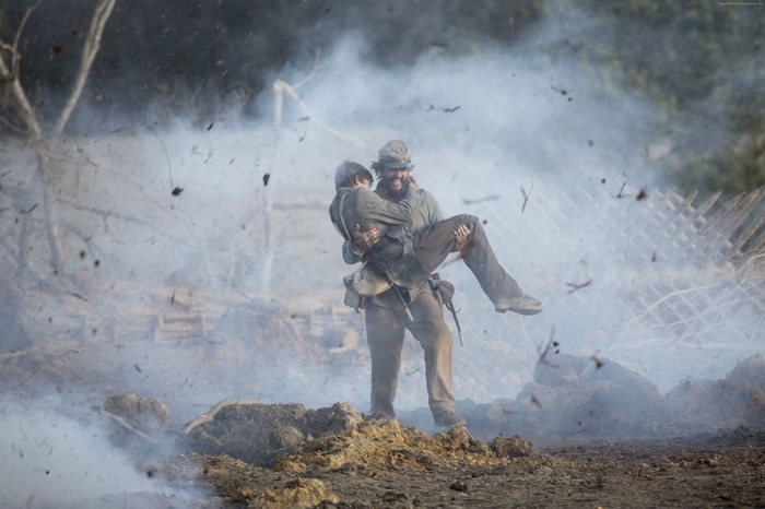 Soldier carrying wounded comrade in battle