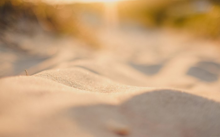 Close-up of sand dunes with sunlight