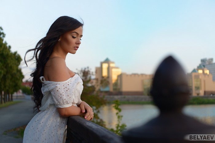 Woman in white dress by the water