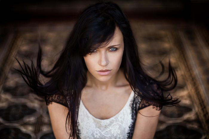 Woman with long black hair and blue eyes