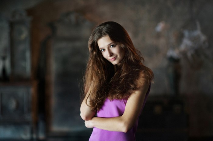 Portrait of a young woman with long brown hair