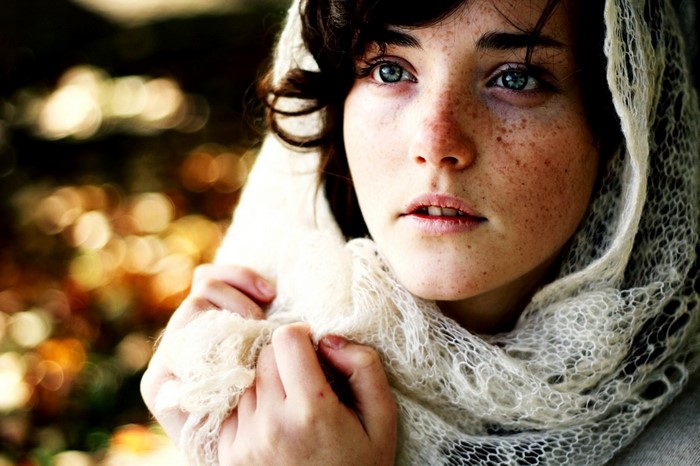 Woman with freckles wearing a scarf
