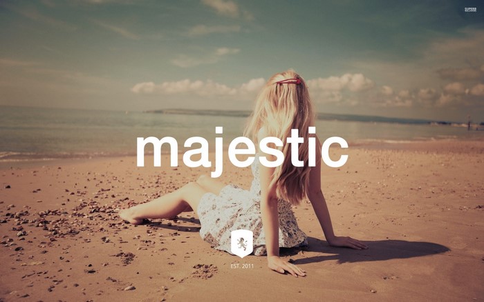 Majestic logo on a beach with a woman sitting