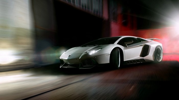White Lamborghini Aventador driving at night