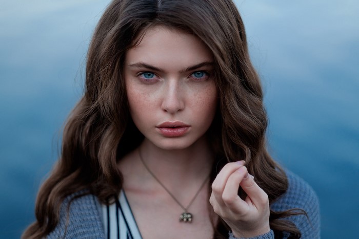 Close-Up Portrait of Woman with Blue Eyes and Wavy Hair