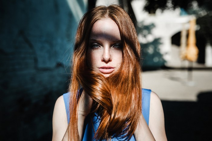 Redhead woman with freckles in blue dress