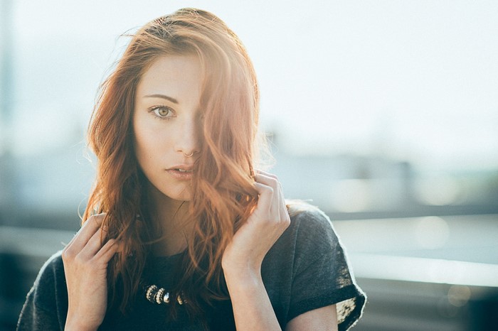 Woman with red hair and nose ring