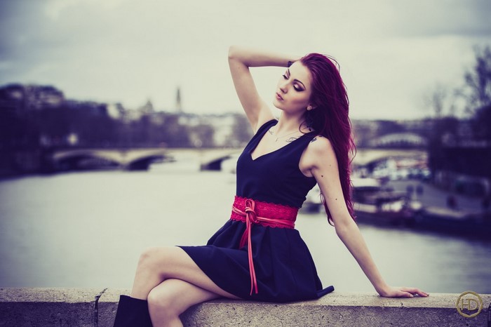Woman with dyed hair sitting by a river