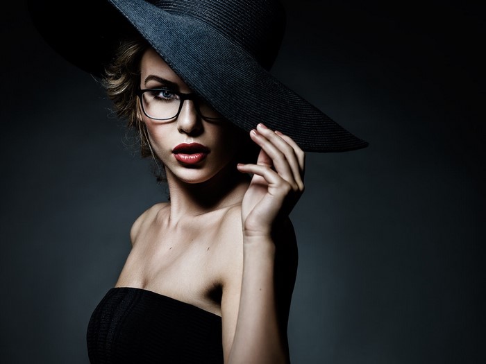 Woman in black hat and glasses