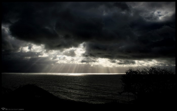 Stormy sky over the sea with sun rays