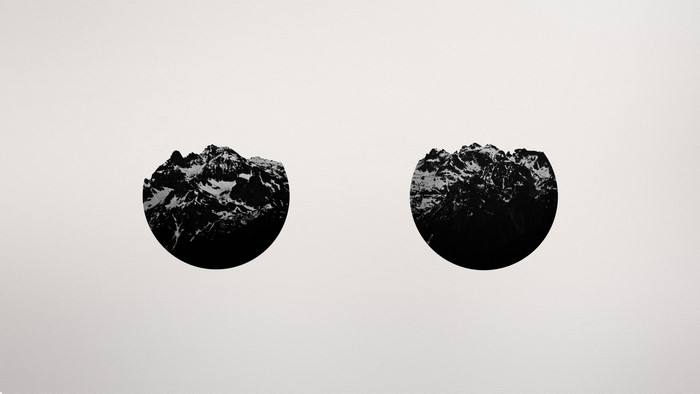 Two circular mountain range illustrations