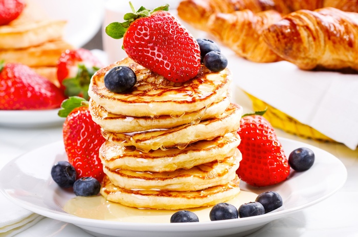 Stack of pancakes with strawberries and blueberries