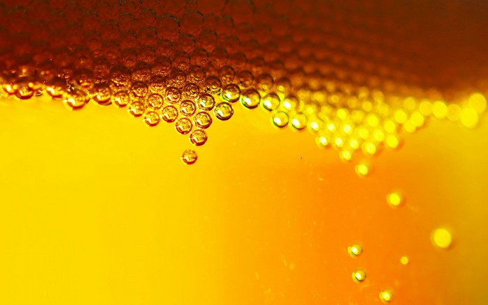 Close up of beer bubbles in sunlight