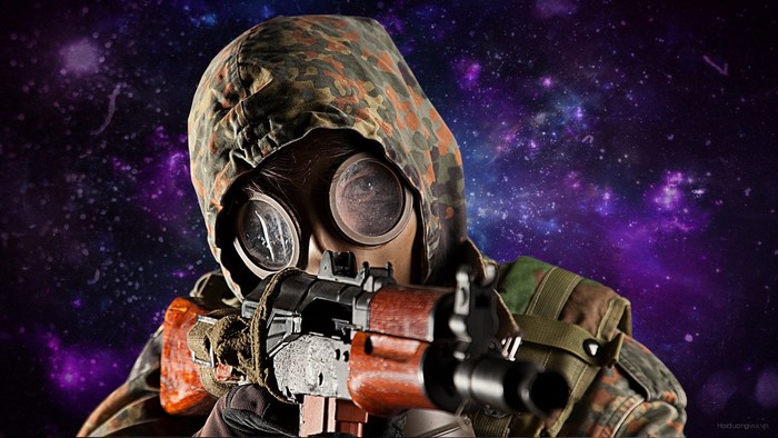 Person in gas mask and camouflage holding AKS 74U in space