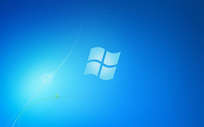 Windows 7 logo on a blue background with light effects