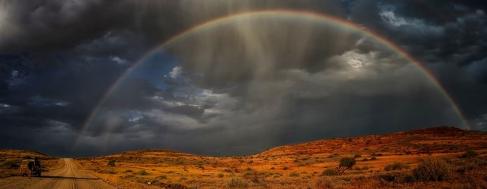 Rainbow over a dirt road in Namibia