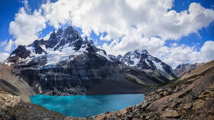 Snowy Andes Mountains with Turquoise Lake under Blue Sky