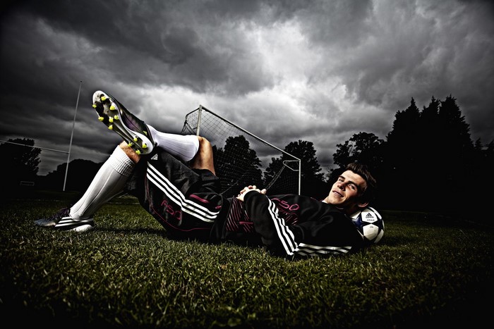 Gareth Bale lying on a football field