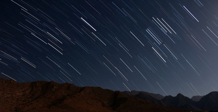 Star trails over mountains at night