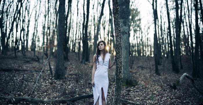 Woman in white dress in a forest