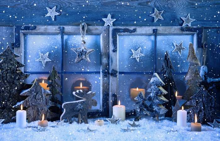 Christmas window decorations with candles and snow