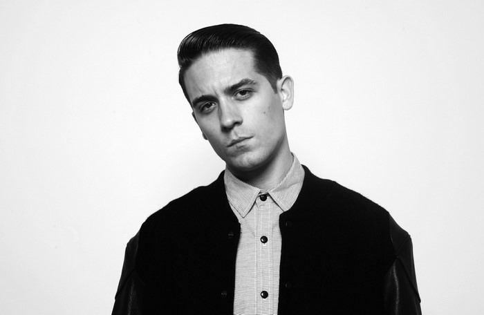 G-Eazy in a black jacket and striped shirt